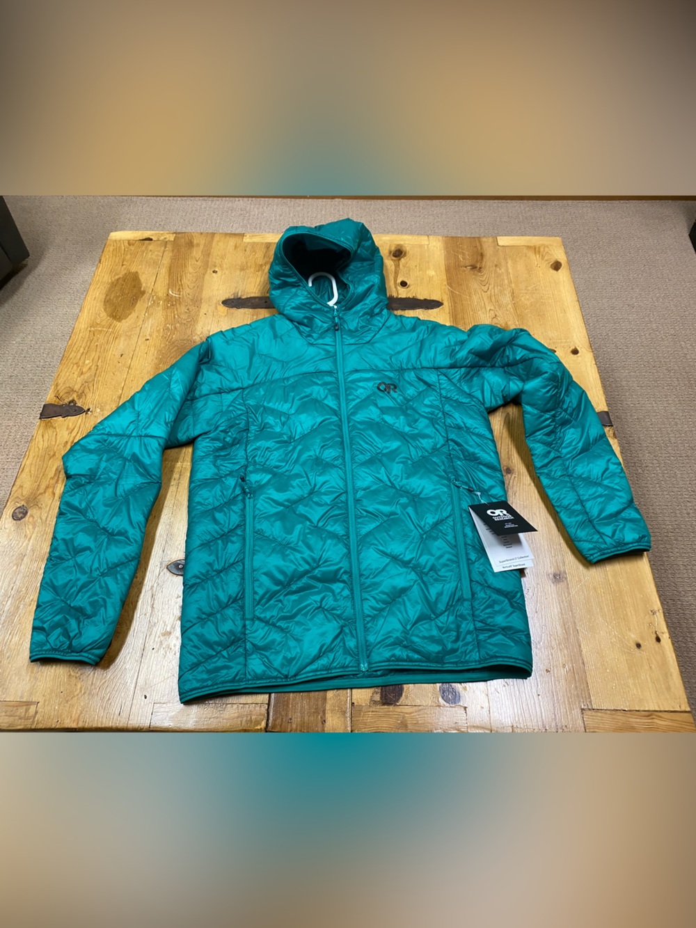 Outdoor Research Men's Teal Hooded Puffer Jacket. Color is a rich green.